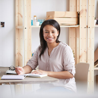 smiling-mixed-race-woman-at-desk-PY2ZLH6.jpg